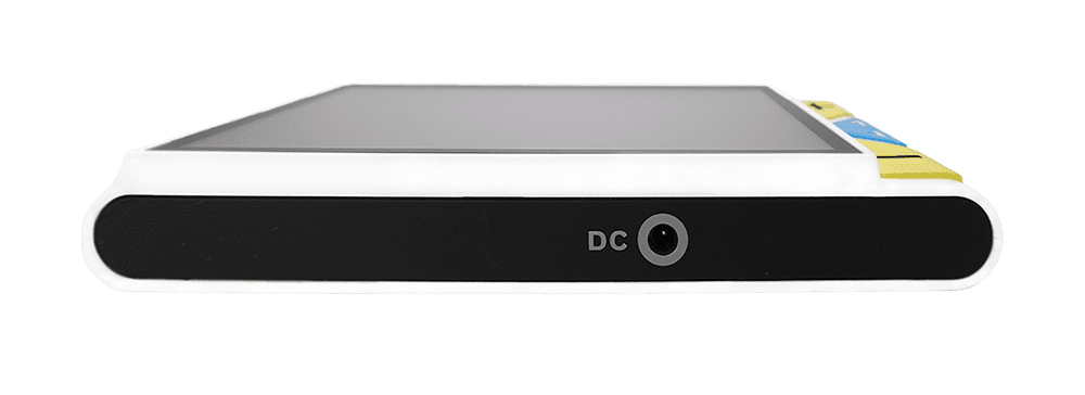 A digital audio workstation interface device, resembling a laptop or controller, shown from a side angle against a solid green background. The device features a white outer frame, a black front panel with a DC label and circular port, a gray top surface, and small yellow and blue buttons on the right side. Clover 5 Special Needs Computers.