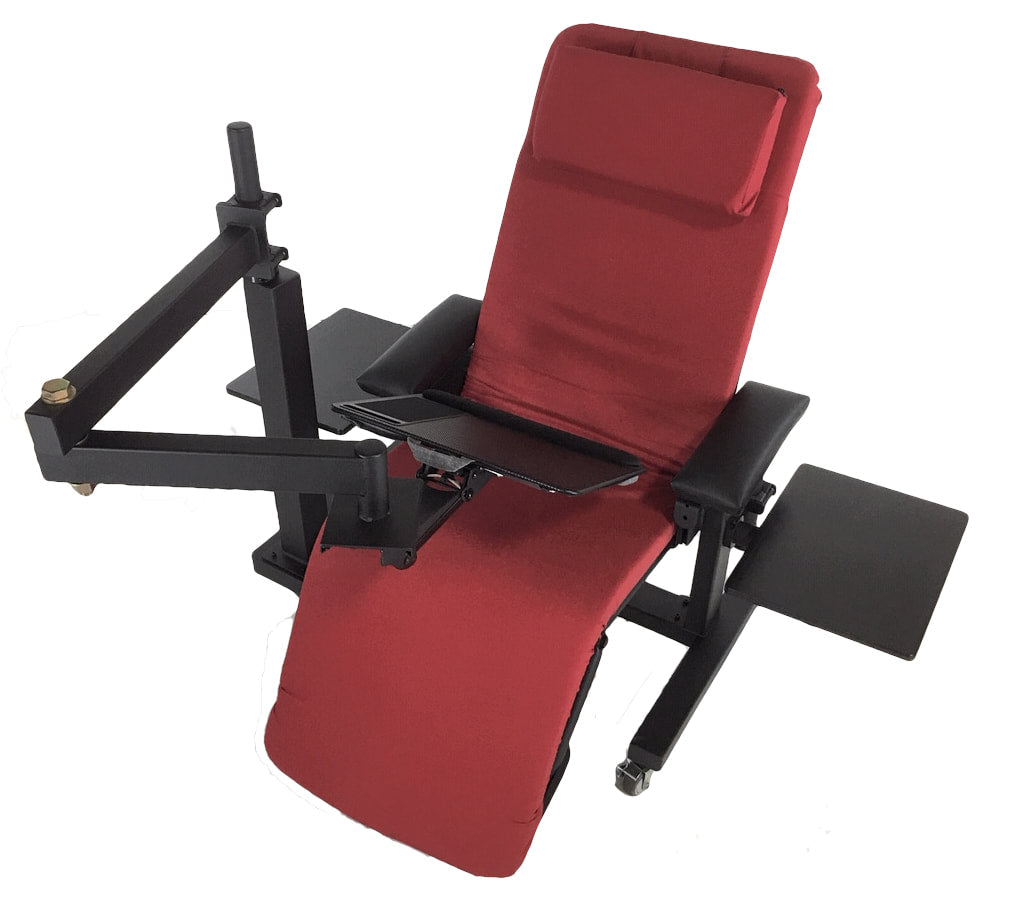 A red and black adjustable reclining massage chair with a headrest, armrests, and a fold-out tray table, shown on a plain white background. Zero Gravity Workstation 1b. Special Needs Computers.