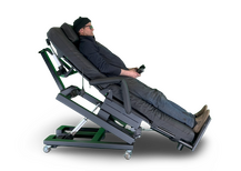 An electric adjustable recliner chair with a person lying down on it, shown against a plain white background. Zero Gravity Chair 4-Lift. Special Needs Computers.ca