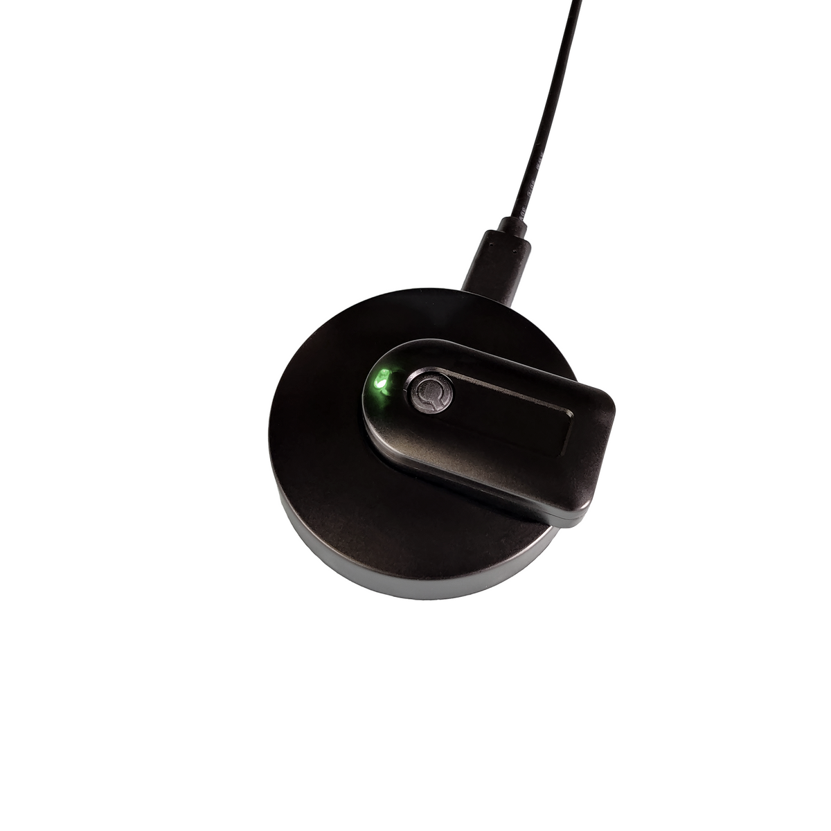 A black circular wireless charging pad with a matching black charging module resting on top, featuring a small green LED indicator light, shown against a solid white background.