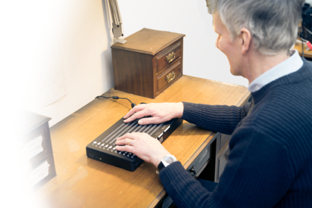 Man Using Canute Braille E-Reader
