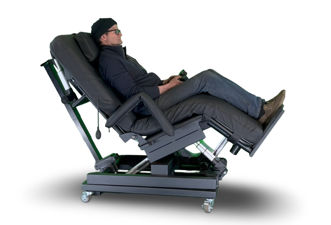 A man reclining in a black adjustable power massage chair with green mechanical components, shown from a side profile against a white background.  Zero Gravity Chair 4-Lift. Special Needs Computers.ca