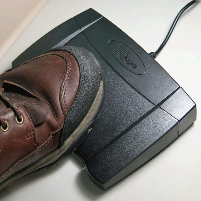with foot on  X-keys USB Mouse Click Foot Pedal